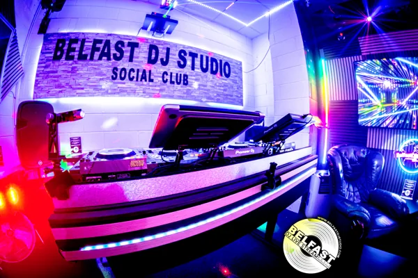 SocialClub’s DJ booth, illuminated studio sign and lounge