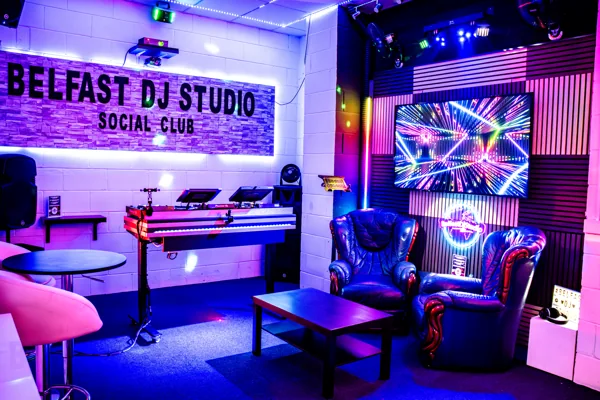SocialClub lounge seating and club lighting beside the DJ booth