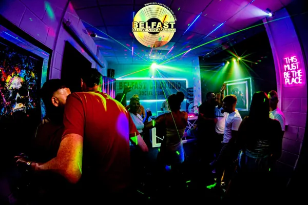 Friends enjoying a SocialClub party under colourful laser lights