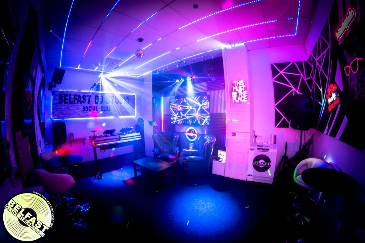 SocialClub’s private room with lounge seating, colourful lights and a DJ booth