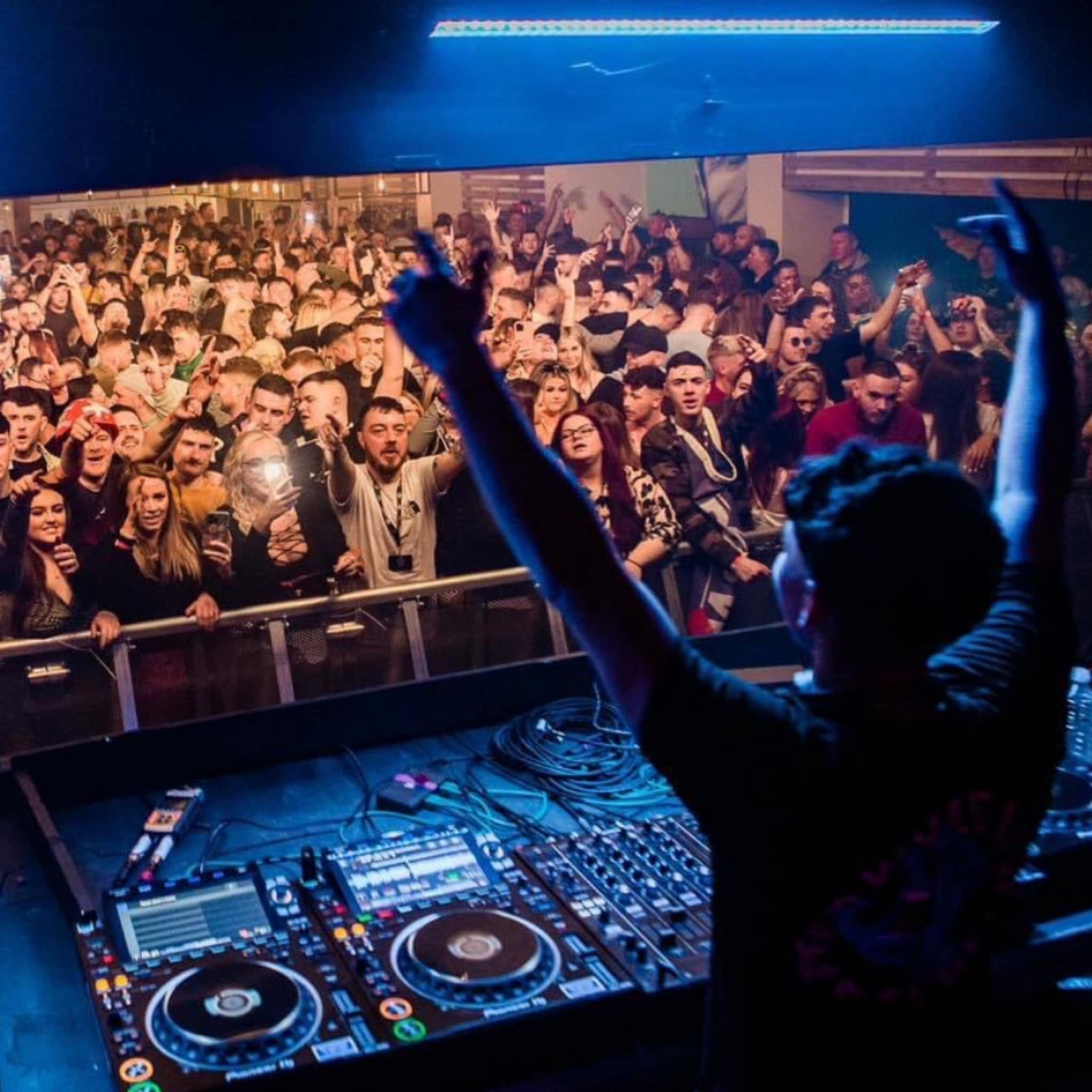Tyler Jack performing to a packed club crowd