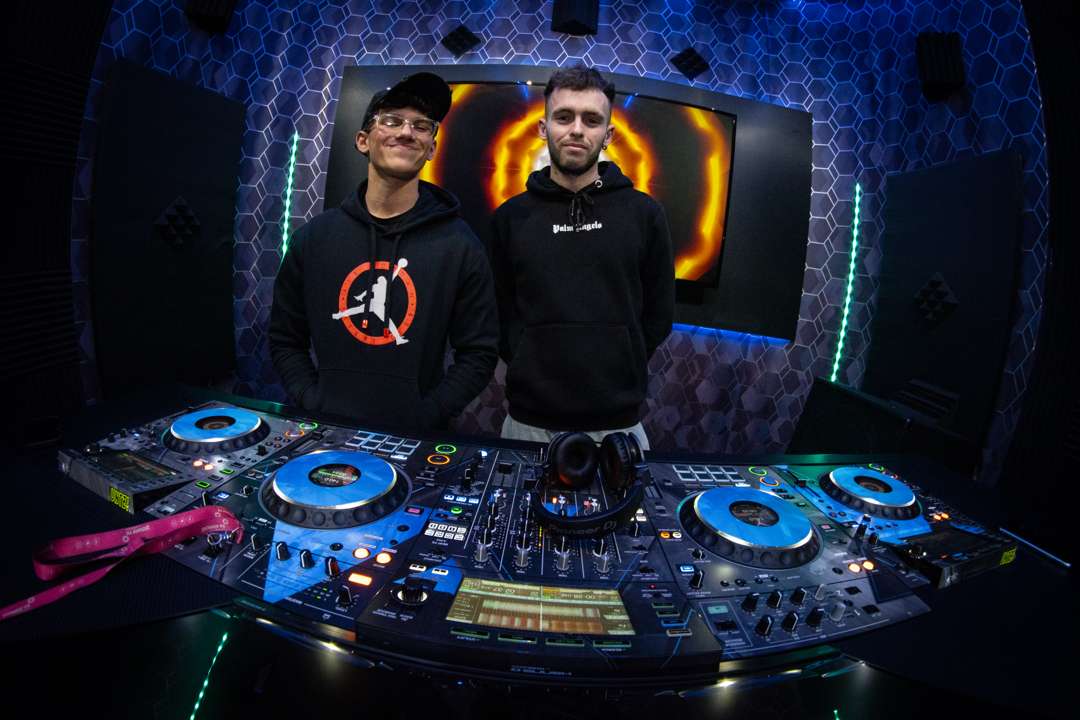 Tyler Jack with a student behind professional decks